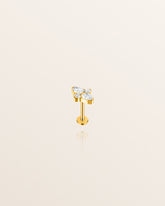 A single gold stud earring with a flat back and four white stones set in it, designed for forward helix ear piercings or other ear piercings.