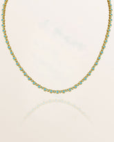 Tennis Necklace with turquoise stones on a white background